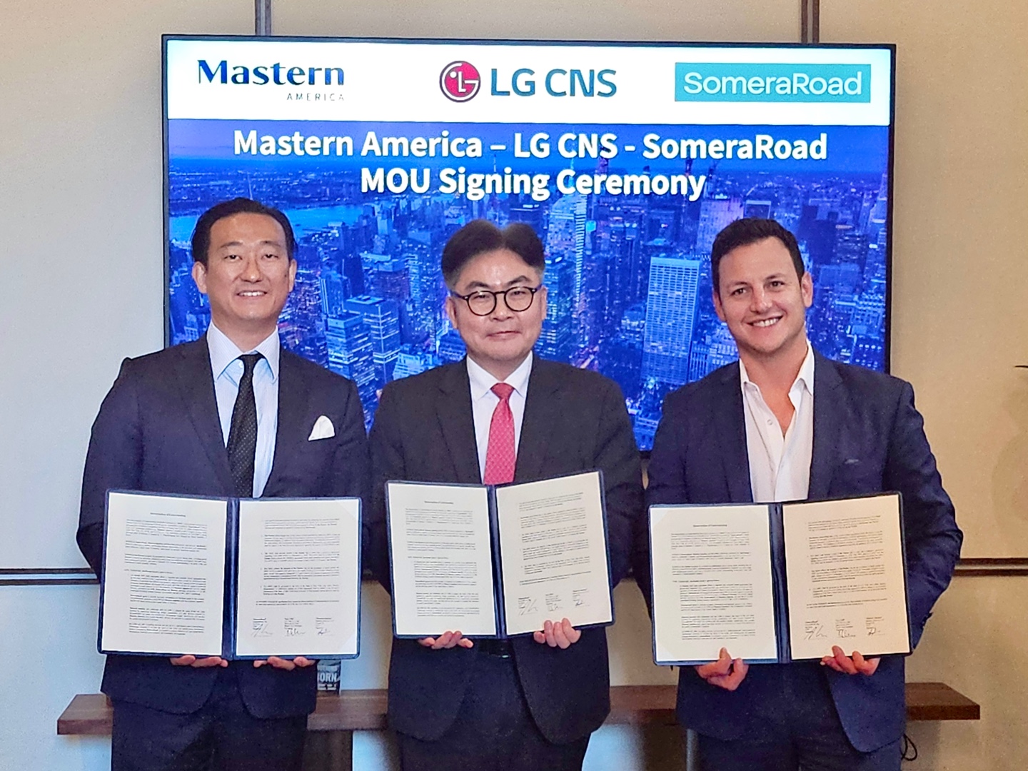 Photo-Moon-Keun-ChoiMiddle-SVP-of-LG-CNS-takes-a-photo-with-Ian-Rossright-Managing-Partner-of-SomeraRoad-and-Joseph-Ohleft-CEO-of-Mastern-America-after-signing-MOU.jpg